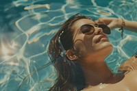 Women lying down in the sun wearing glasses on the pool accessories photography recreation.