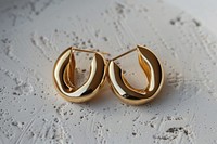 Gold hoop earrings text accessories accessory.
