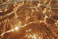 Aesthetic brown sand beach wallpaper water outdoors texture.