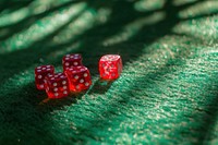 Rolling red dices on a green casino felt medication urban game.