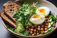 A bowl with spiced chickpeas and egg on top brunch bread plate.