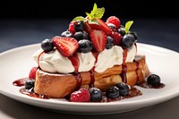 A French toast with berries and cream on top plate berry food.