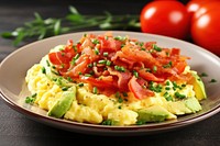 Scrambled eggs with bacon and avocado brunch plate food.