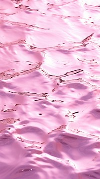 A pink background with water ripples texture blossom purple.