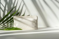 A cosmetic bag handbag white accessories.