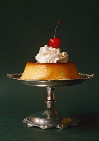 An old-fashioned flan with whipped cream and a cherry on top food cheesecake dessert.