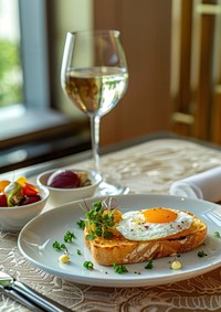 Fried egg on toast with green leaves sprinkled over it plate glass food.