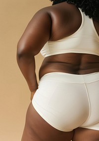 African american chubby woman in white activewear underwear clothing lingerie.