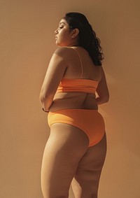 Asian chubby woman in brick orange activewear photo back photography.