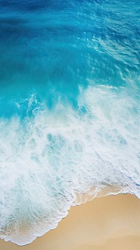 A surreal aerial view of the beach and ocean shoreline outdoors nature.
