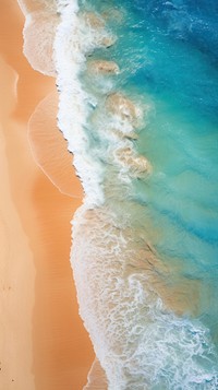 A surreal aerial view of the beach and ocean shoreline outdoors wedding.