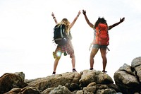 Female backpackers on cliff