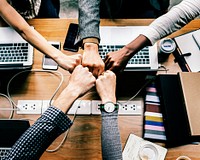 Diverse businesspeople giving fist bump