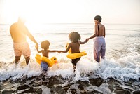 Black family enjoy the beach