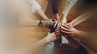 Diverse people stacking hands together