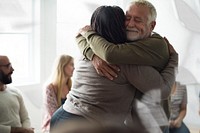 Senior man hugging woman in support group