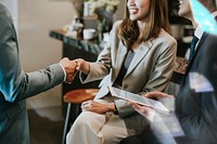 Business people shaking hands in a cafe