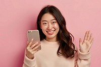 Smiling woman holding smartphone