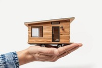 Hand holding miniature wooden house