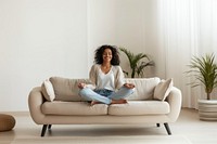 Relaxed woman meditating on sofa