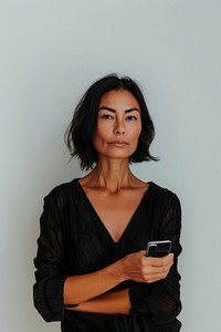 Confident woman holding phone