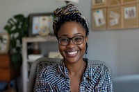 Smiling woman with glasses indoors