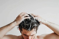 Man washing hair with shampoo