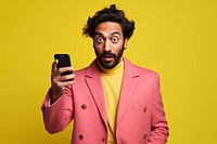 An 27 yo indian pointing at his phone photography portrait fashion. 