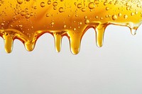 Golden honey dripping with bubbles