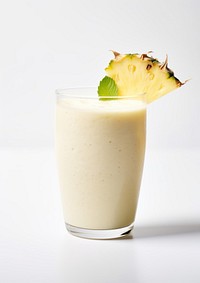 A glass of Pineapple Coconut Smoothie pineapple smoothie beverage.