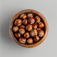 Nutritious hazelnuts in wooden bowl