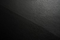 Dark textured black background surface