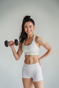 Woman exercising with dumbbell smiling