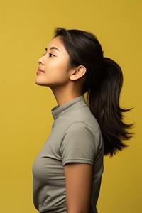 Profile portrait woman yellow background