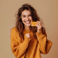 Happy woman holding credit card