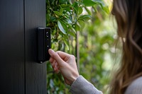 Hand using the doorbell technology security camera.