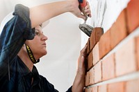 Woman bricklayer building wall image