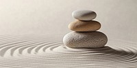 Three stones on top of each other in the center ripples sand tranquility.