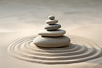 Balanced stones on sandy surface