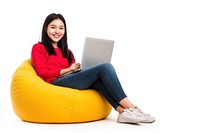 Cheerful asian woman working on laptop seated on a minimal luxury color beanbag person electronics comfortable.