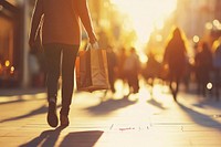 People walking along the street person bags shopping.