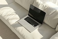 Laptop on white sofa