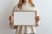 Blank frame held by woman