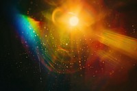 Colorful lens flare with rainbow colors over a black background light astronomy outdoors.