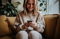 Smiling woman sitting phone mobile phone.