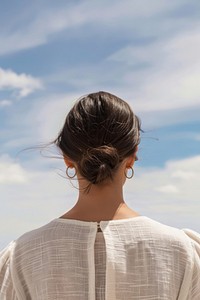 Woman shoulder back view white hair sky.