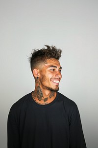 Tattooed man smiling confidently