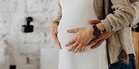 Expecting couple embracing belly