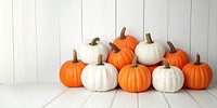 Real pumpkins background orange white.