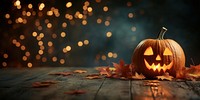 Jack o lanterns on a wood table halloween leaves bokeh.